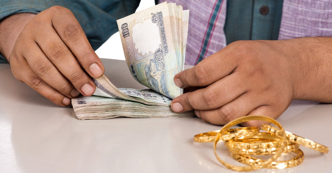 Mid section view of a man counting money